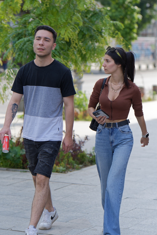 21 - Young couple walking down a street